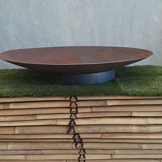 Video showcasing a stunning Corten steel firepit in action. The camera pans over the intricately designed firepit, highlighting its weathered texture and captivating patina. 