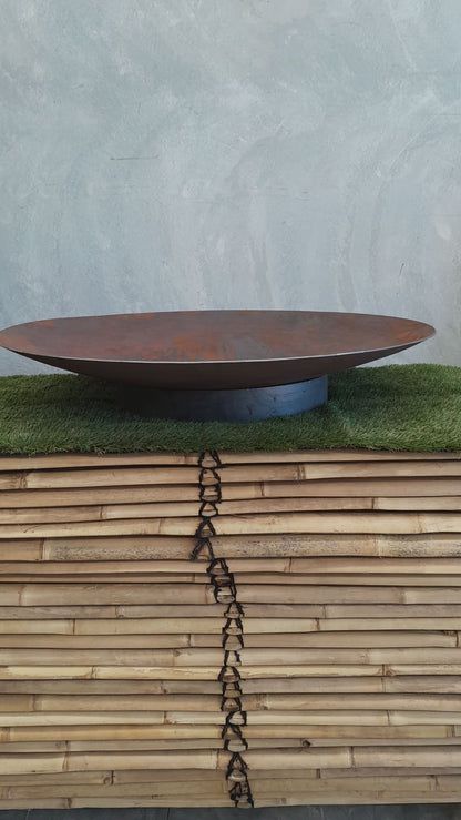 Video showcasing a stunning Corten steel firepit in action. The camera pans over the intricately designed firepit, highlighting its weathered texture and captivating patina. 